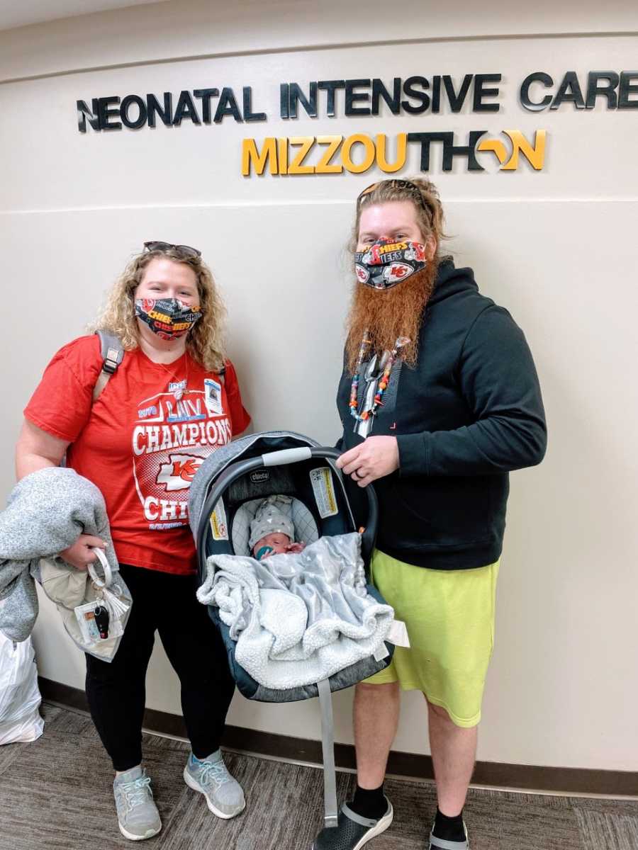 First time parents take photo with their newborn baby as they take him home after being in the NICU