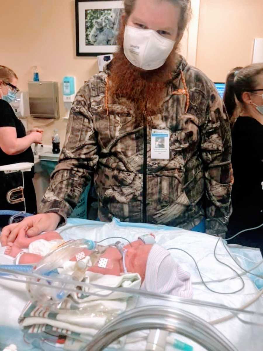 First time father takes photo while holding his newborn son's foot