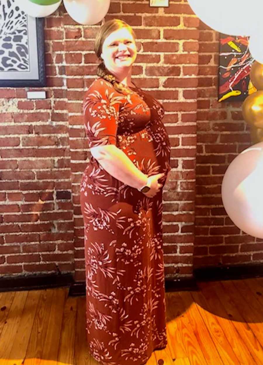 maternity photo of woman in a red dress