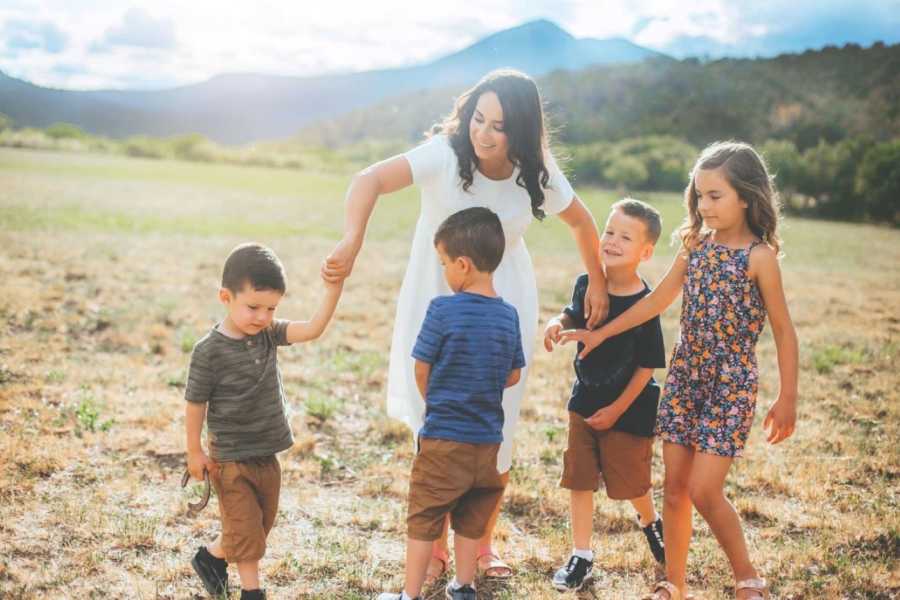 Single mom of 4 twirls her kids around while they dance during a family photoshoot