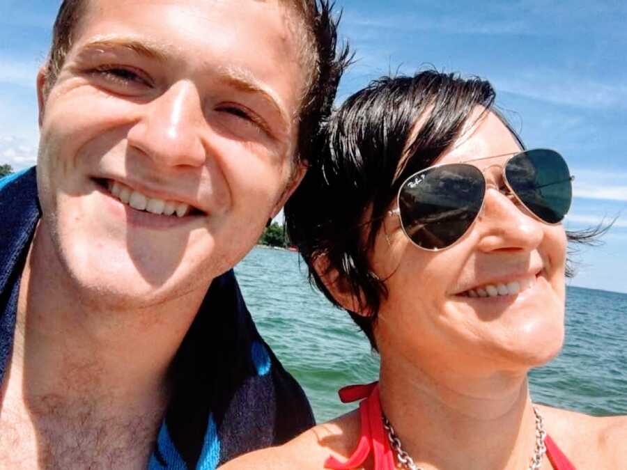 Mom takes a selfie with her oldest son while on a boat together for a family vacation