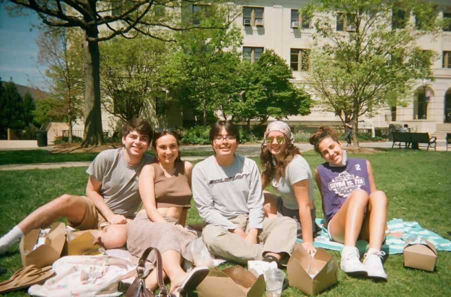 five students on lawn