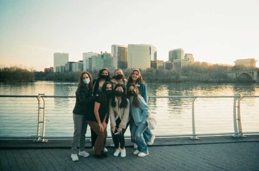 six girls staggered in front of river