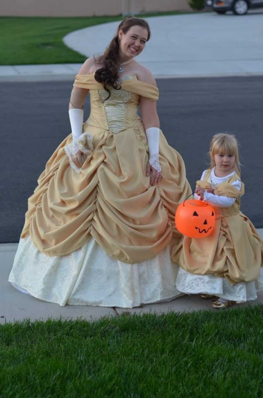 mom and daughter dressed in princess Belle dresses