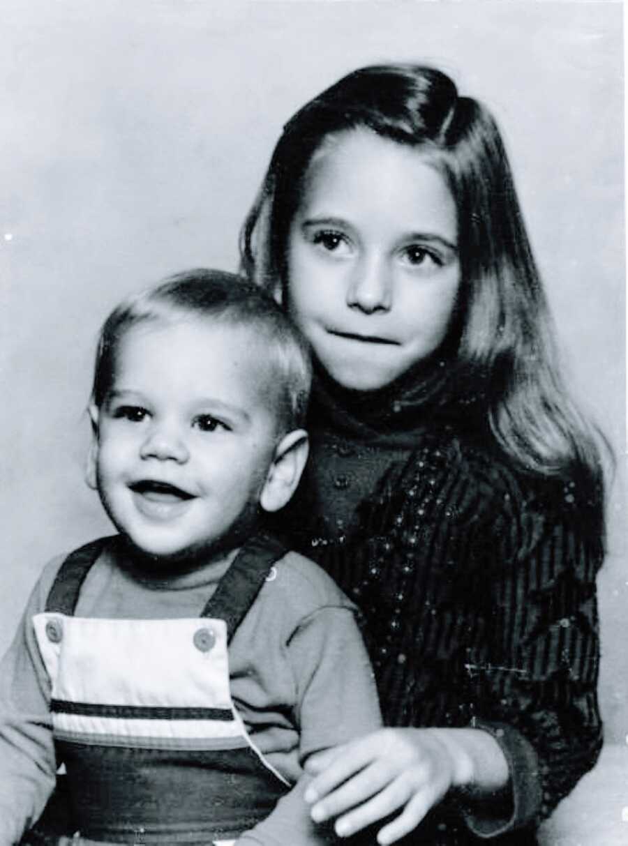 Little girl unknowingly battling autism and ADHD takes a traditional family photo with her little brother