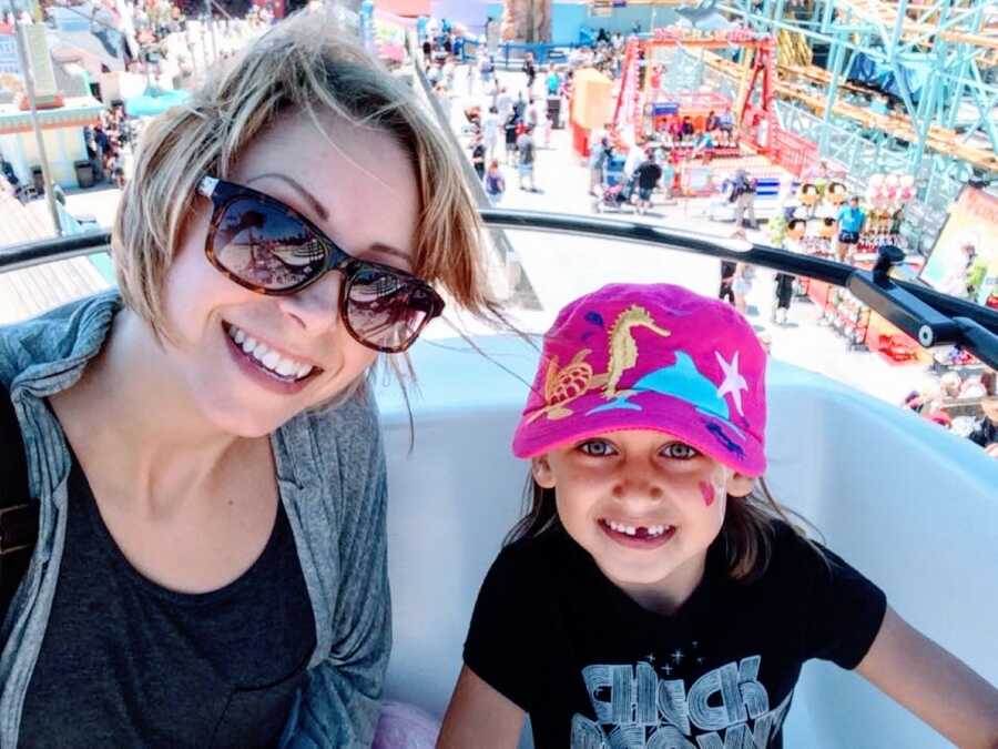 Autistic mother takes a selfie with her daughter while they ride a ferris wheel together at their local amusement park