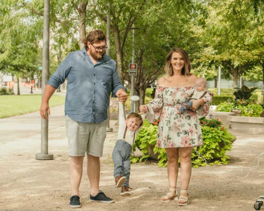 Special needs mom of two boys takes a family photo with her husband and medically complex child