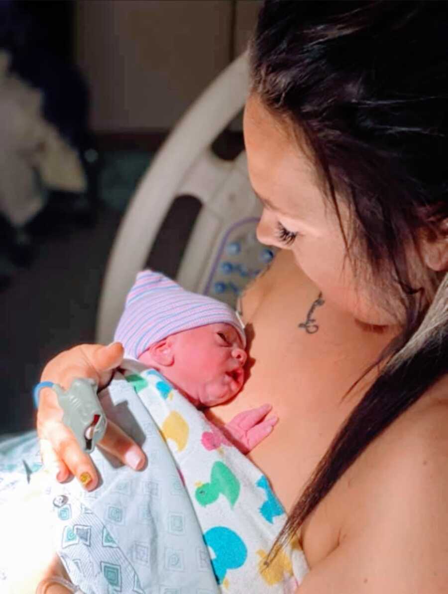 Young mom of 2 holds her newborn preemie son after giving birth