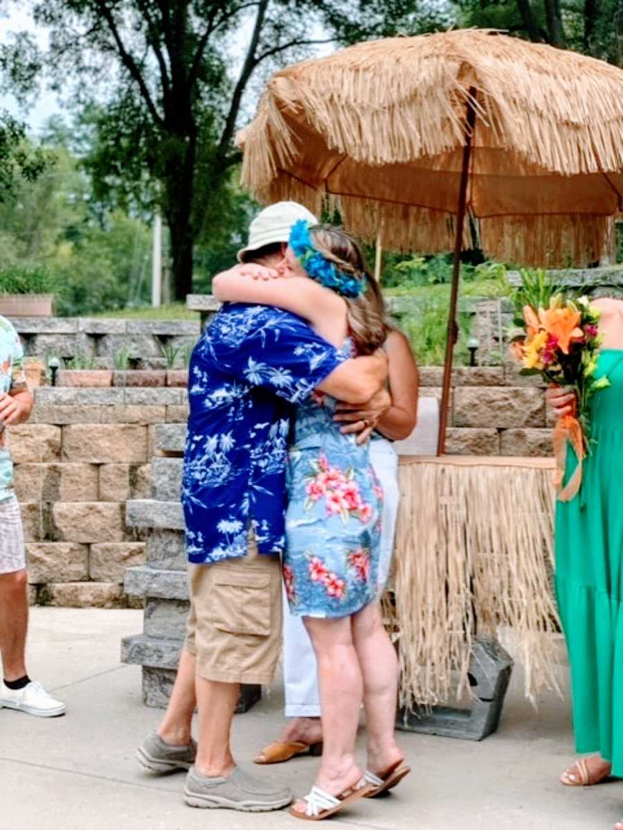 Couple getting remarried after husband recovered from alcoholism share and intimate and loving hug during the ceremony