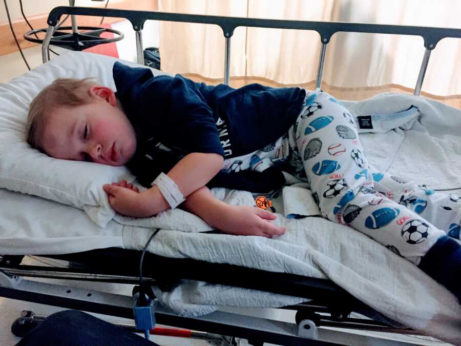 Little boy sleeps in a hospital bed in Toronto during a 6-week stay for various testing