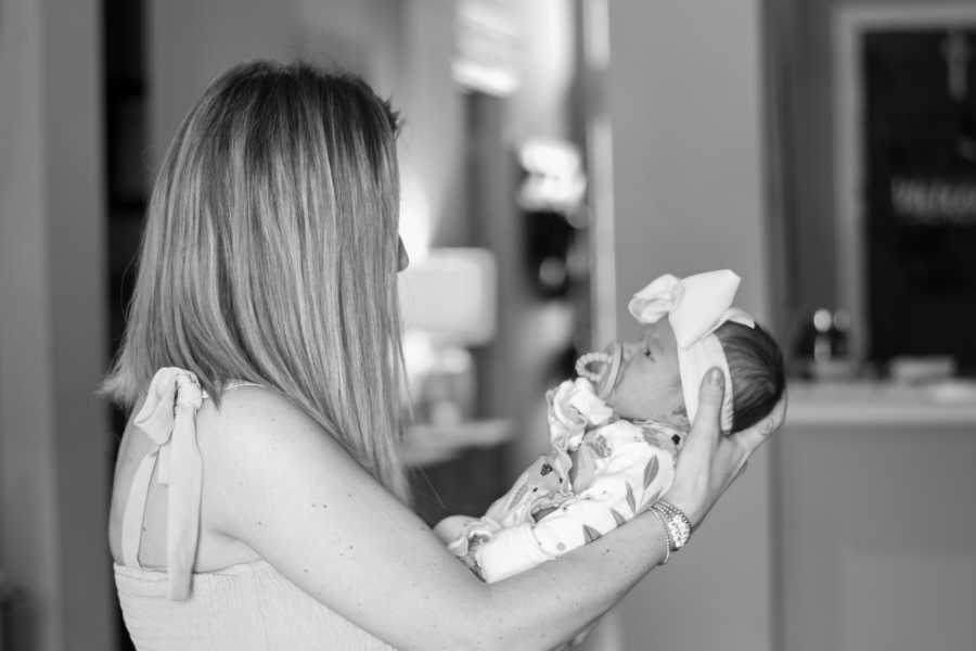 mom holding her daughter