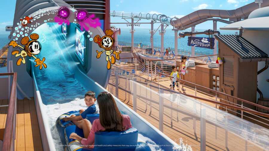 Mom and son sit on a float for the first Disney attraction at sea ride, the Aquamouse on the Disney Wish cruise