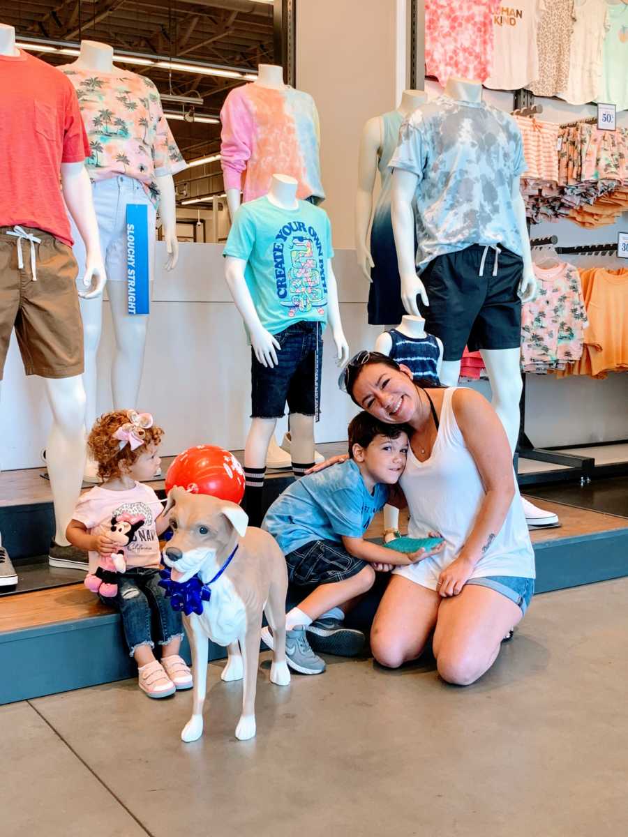 Mom of 2 hugs her autistic son in Old Navy after receiving their very own Old Navy Magic the dog mannequin