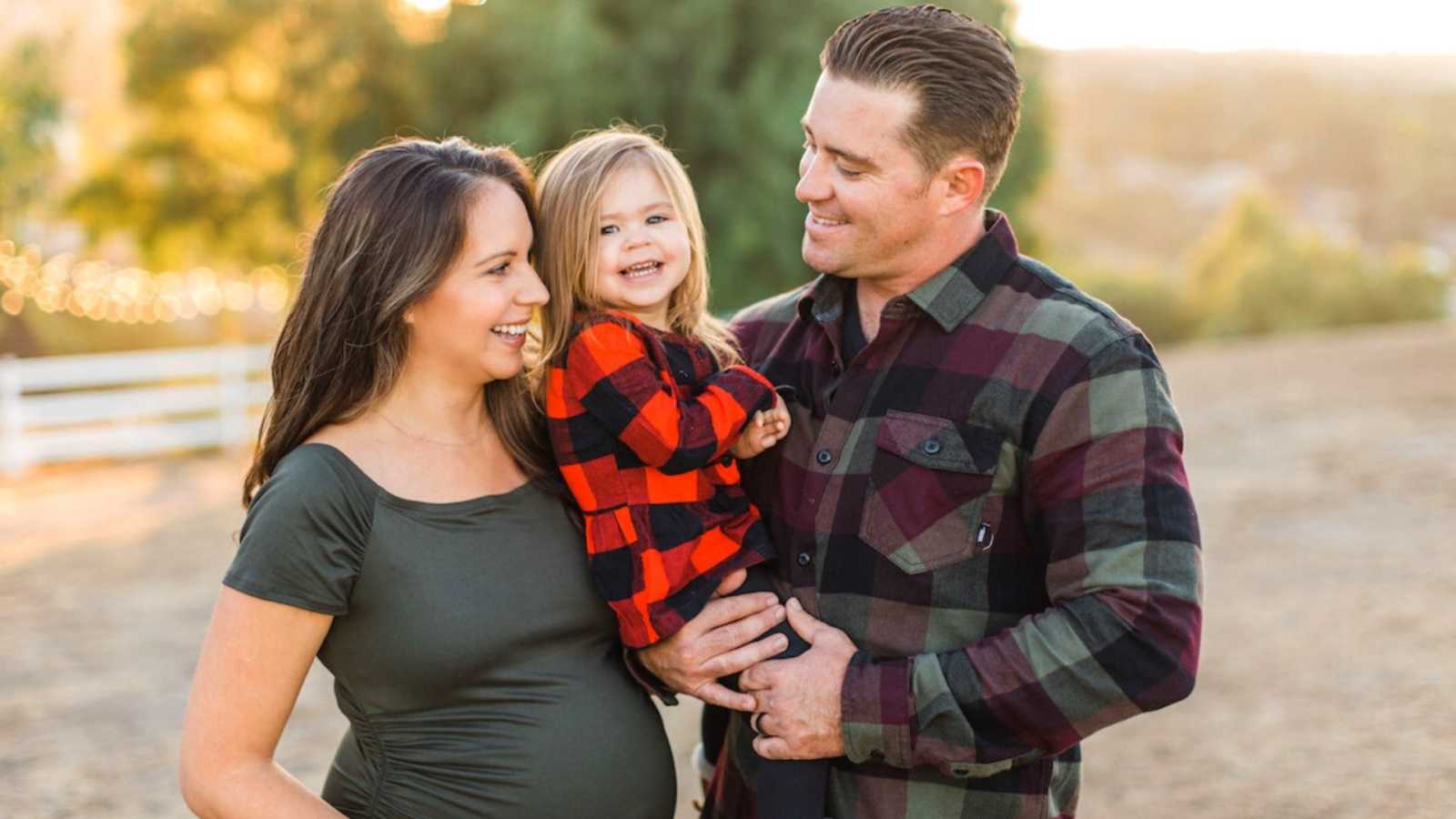 mom, dad, and daughter in fall clothes