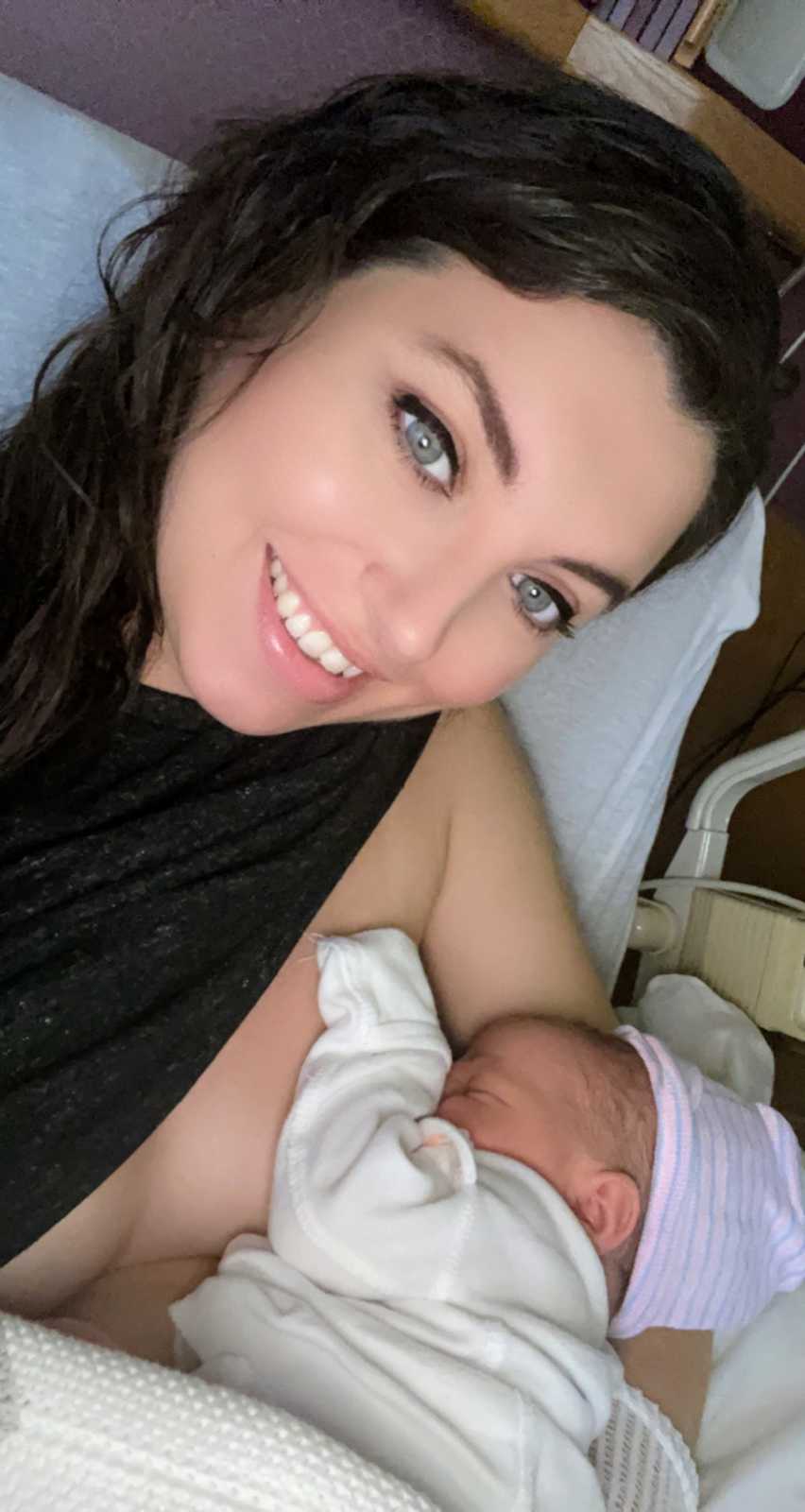 Mom takes selfie while trying to breastfeed her newborn in the hospital