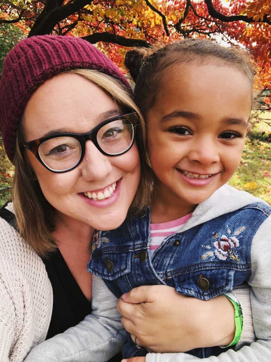 mom and daughter smiling together