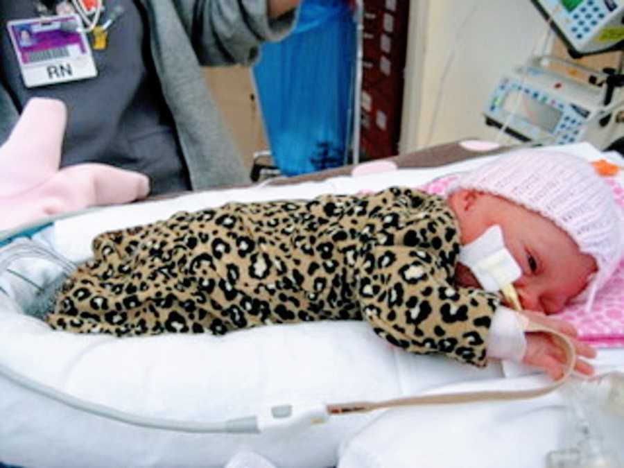 A baby girl lying on a bed in the hospital