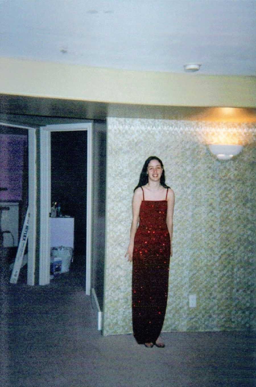 Skinny girl wearing long red dress