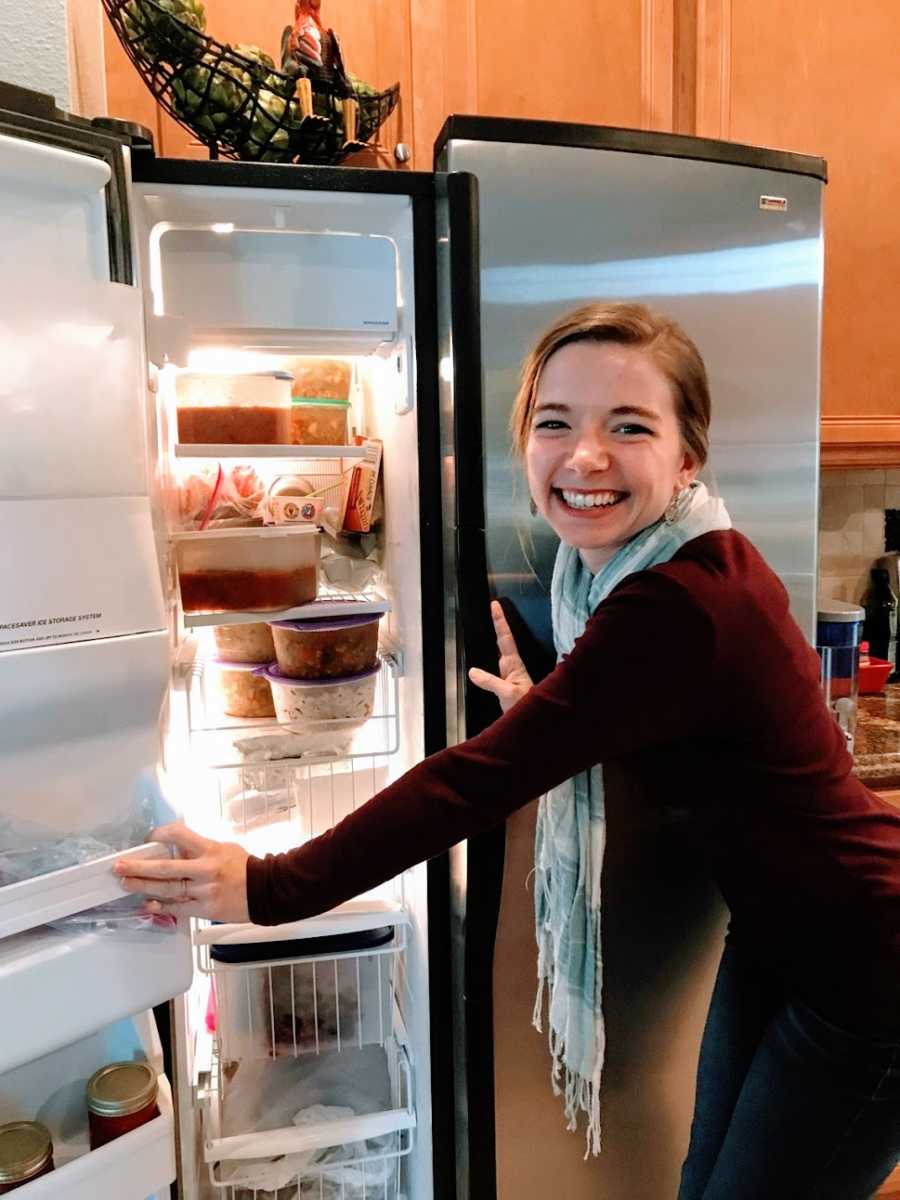 Woman opens packed fridge