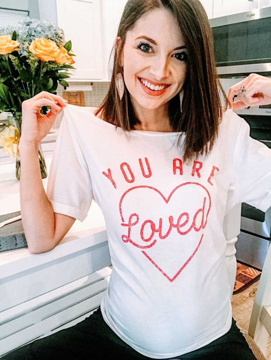 Woman wearing 'You are loved' shirt