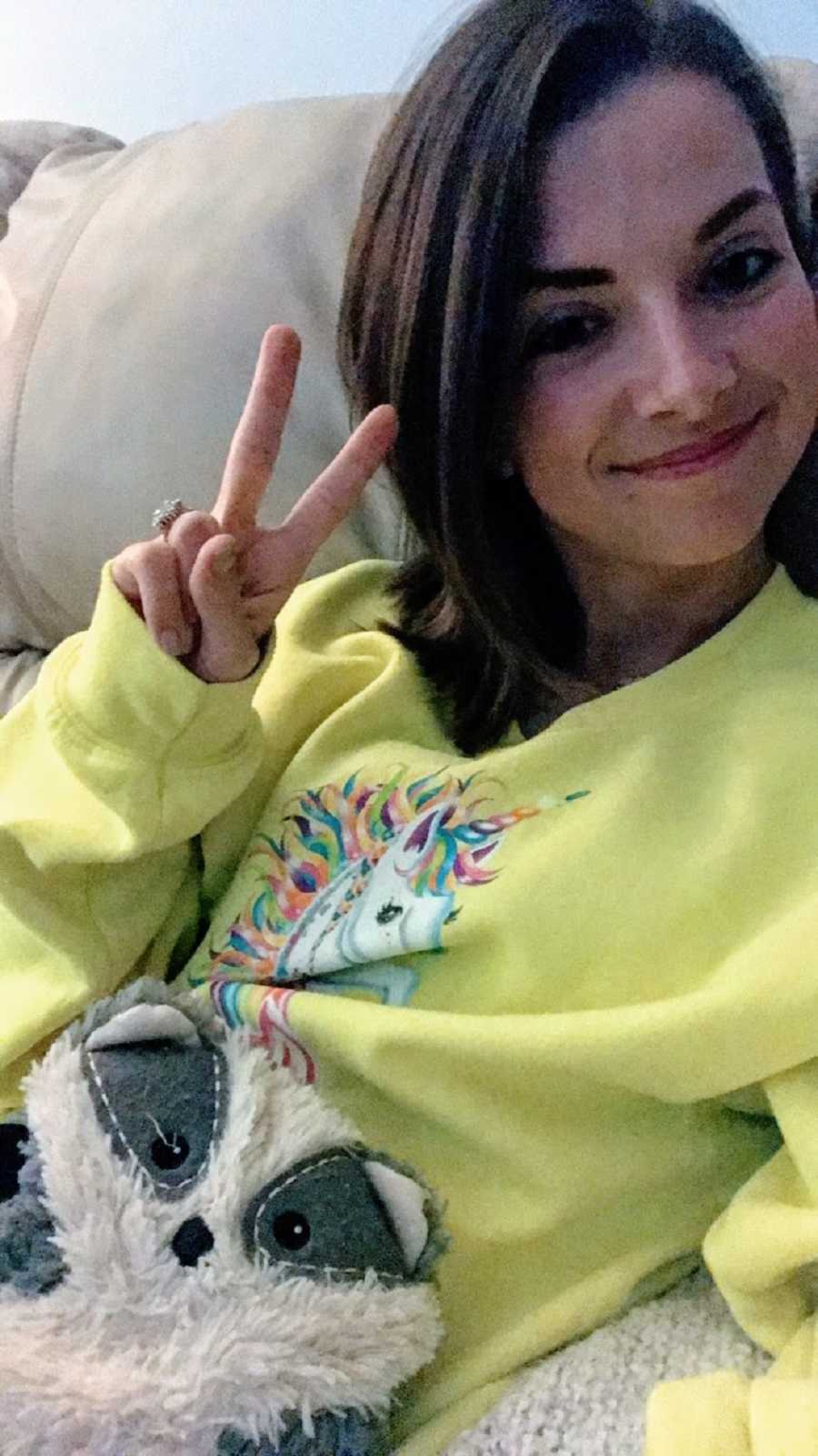 Recovering woman gives peace sign