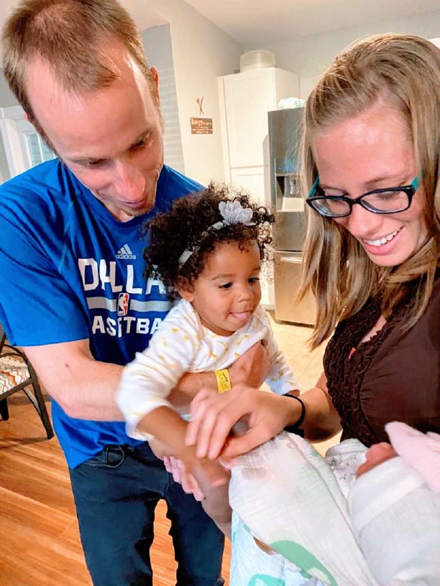 Parents hold their two baby girls