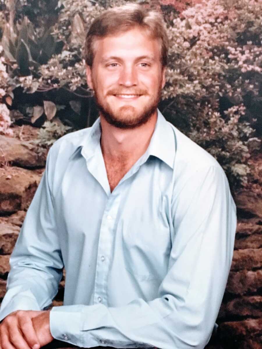 A young man in a blue collared shirt