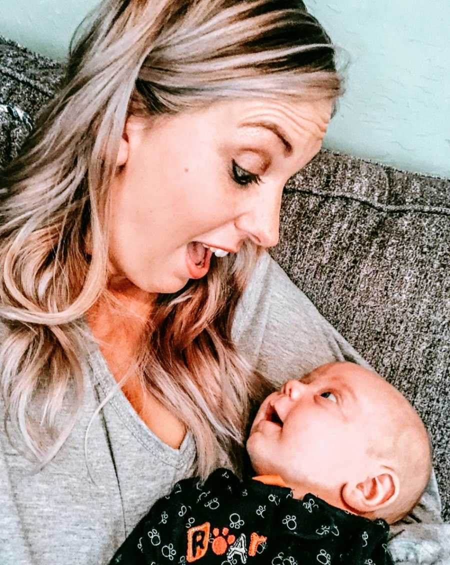 A mother stares in surprise at her baby boy