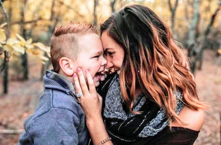 A mom presses her nose to her son's face