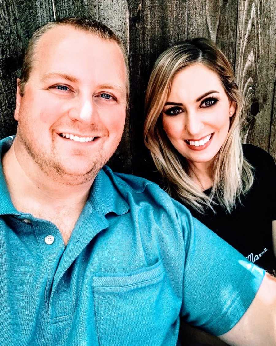 A woman and her husband sit together outside