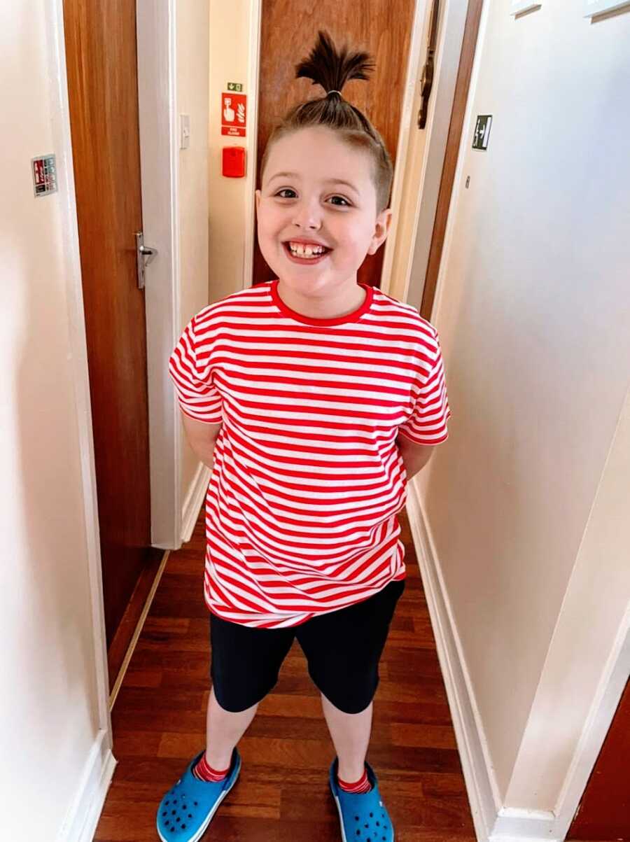 Boy with autism wearing red striped shirt