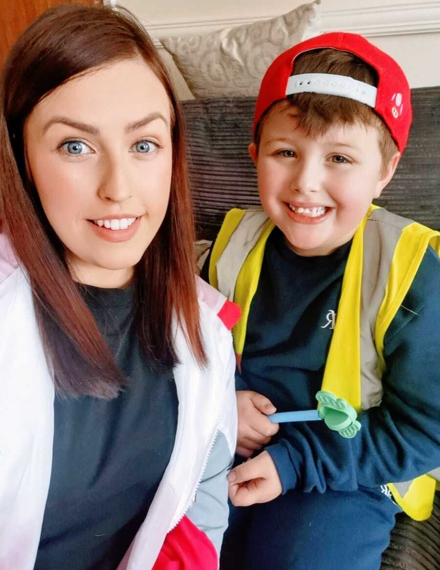 Mom and son with autism who is wearing red hat backwards