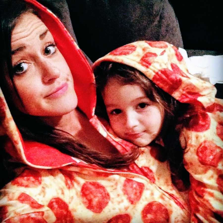 Mother and daughter wearing pizza onesies