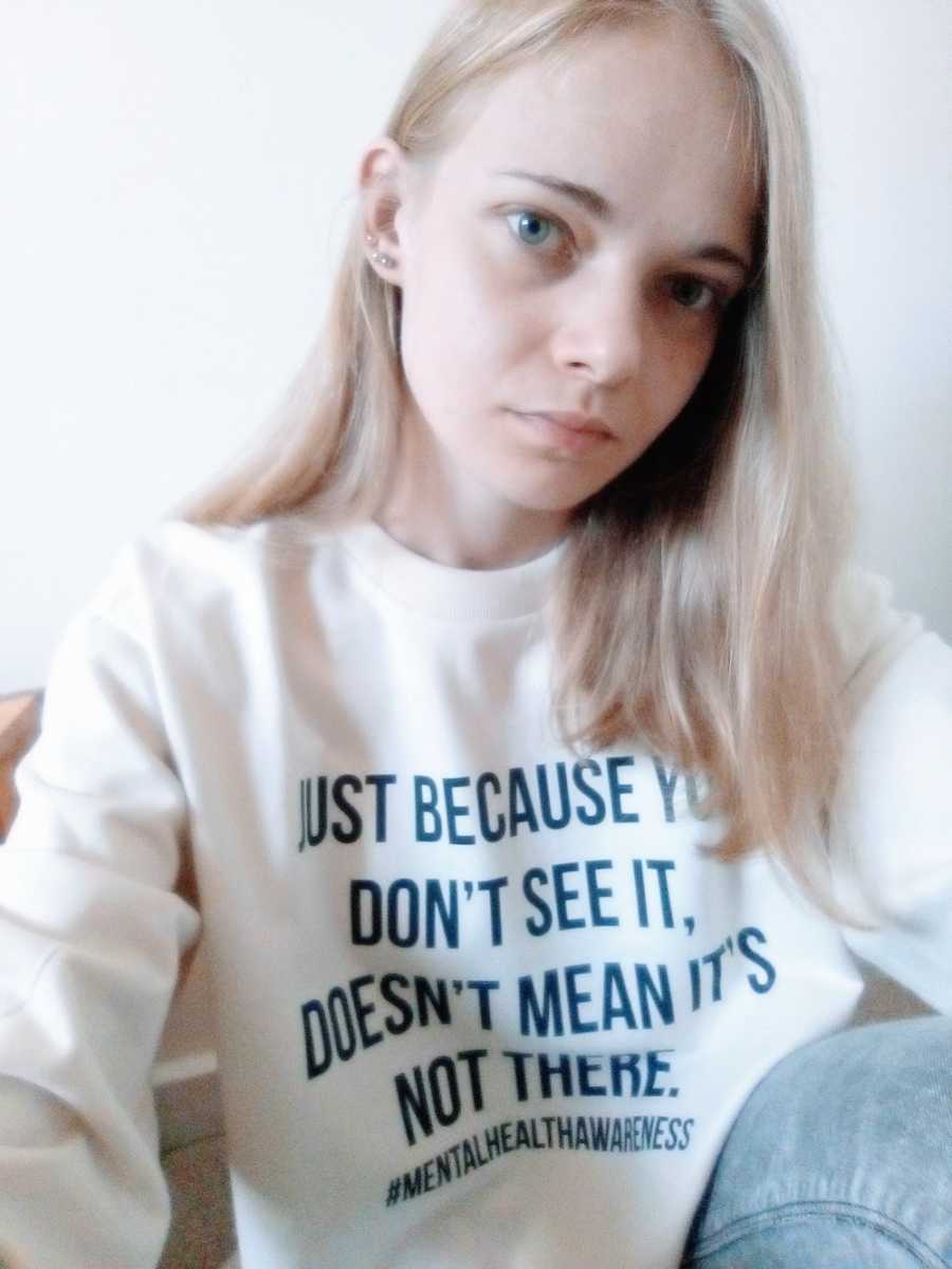 Woman wearing shirt supporting mental health awareness