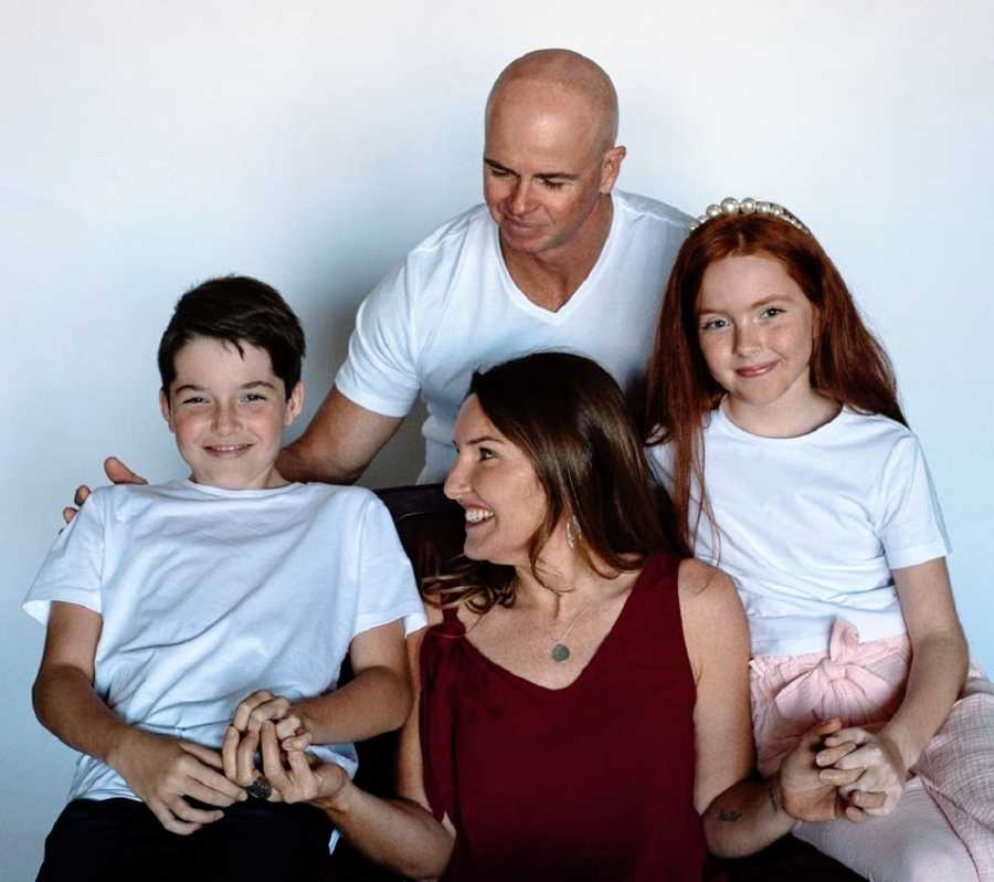 Parents sit with their two young children