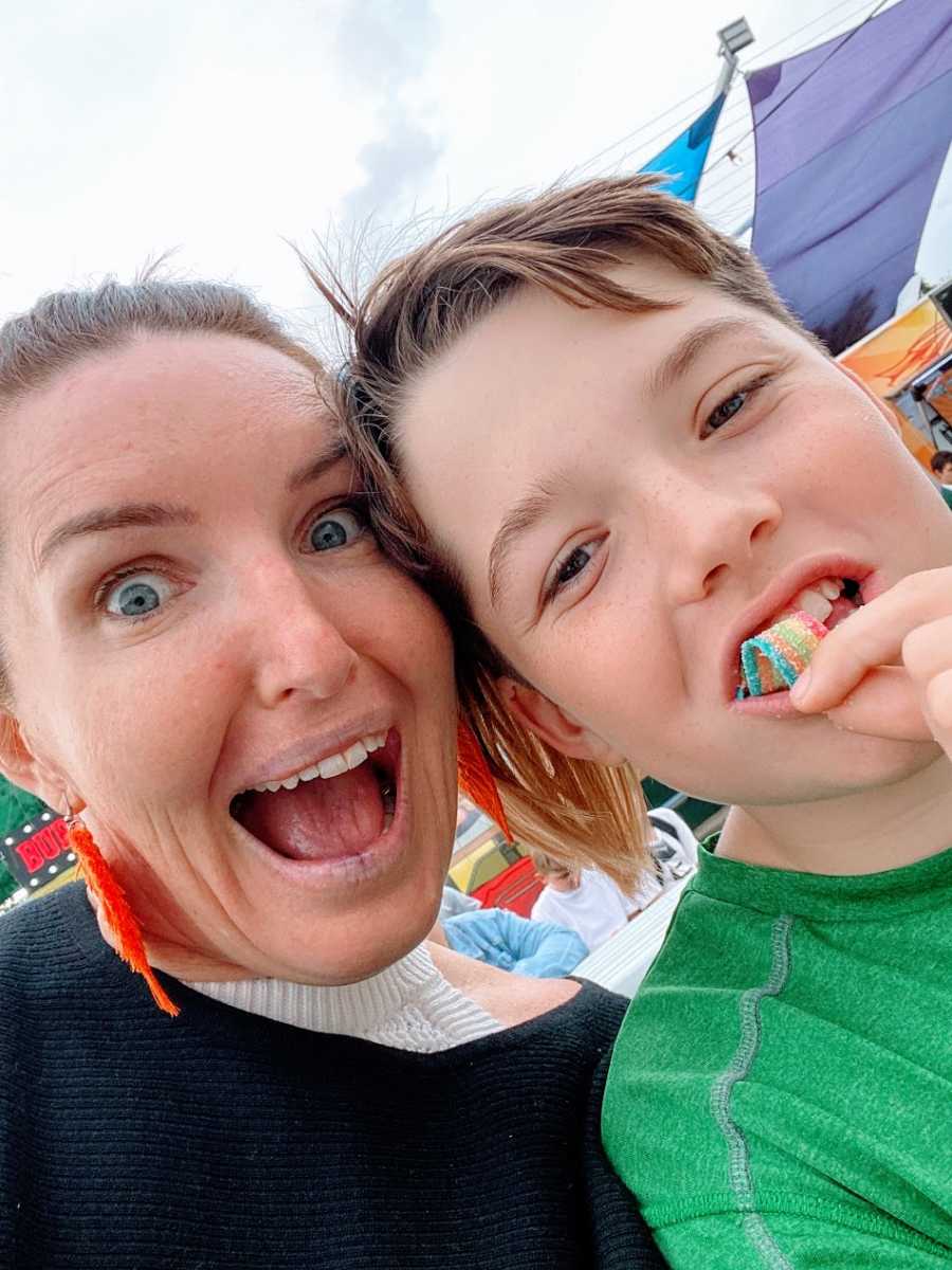 A mom and her young son who has candy in his mouth