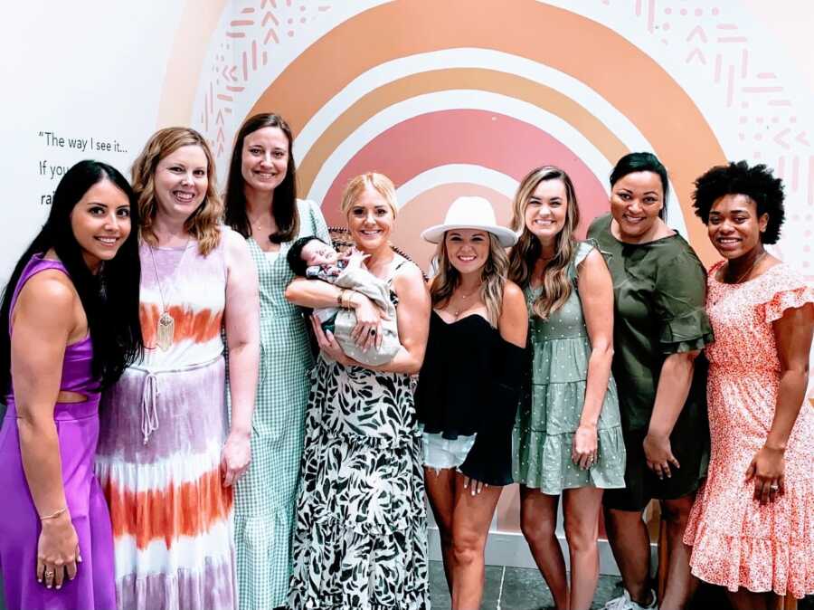 Woman battling infertility takes a photo with her faith-based infertility support group