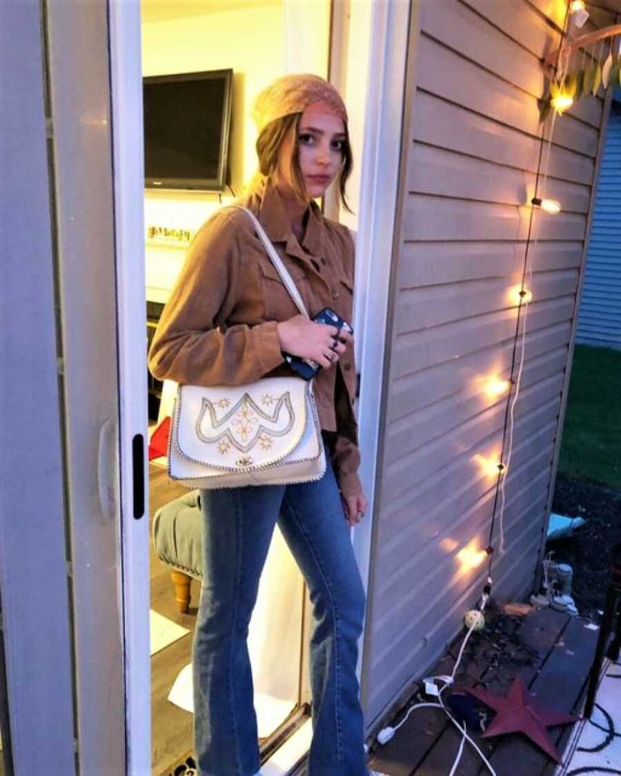 teen posing in doorway