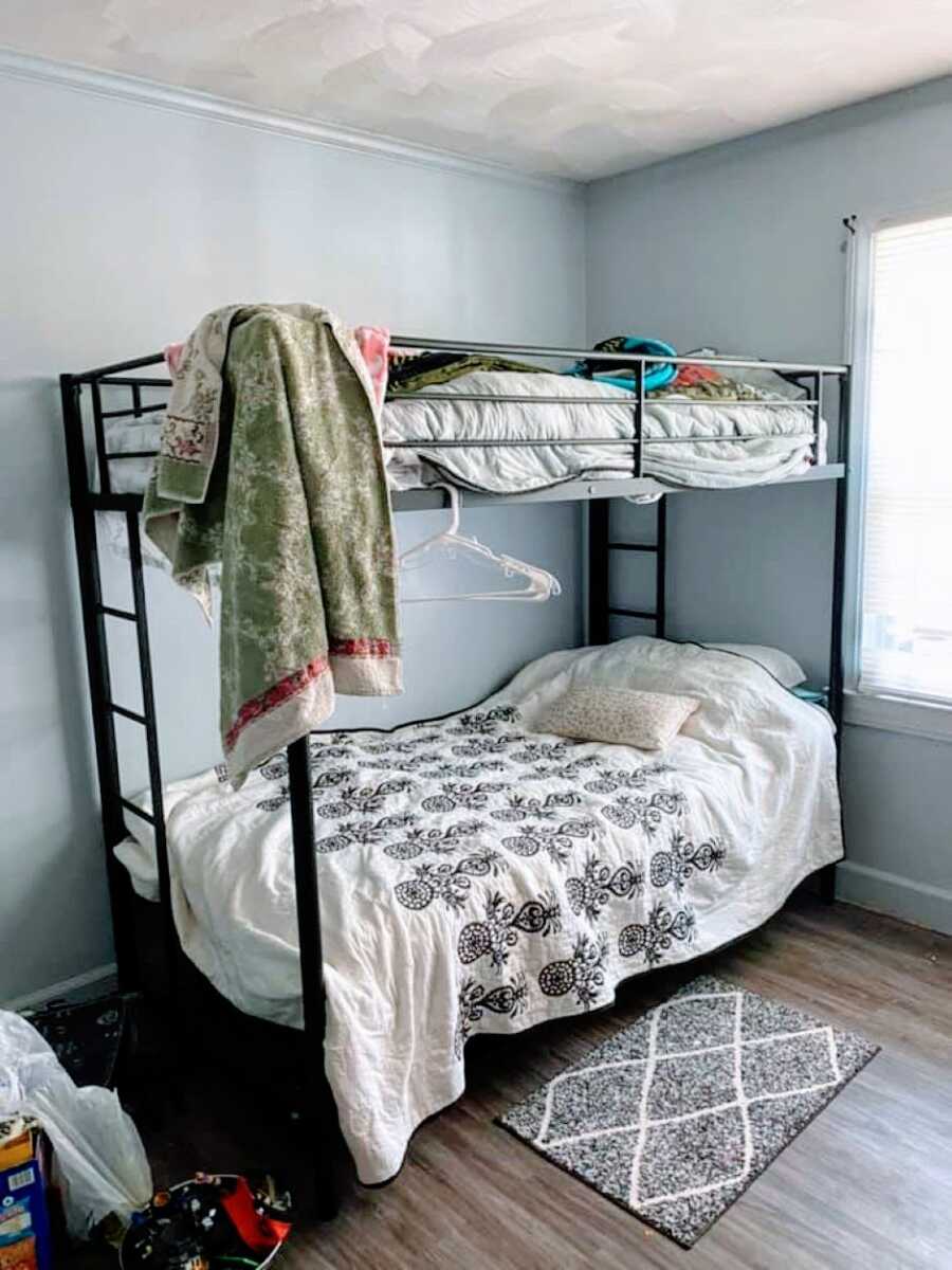 Mom of 3 escaping domestic abuse takes a photo of hers and her son's shared bunkbed in a domestic violence women's shelter