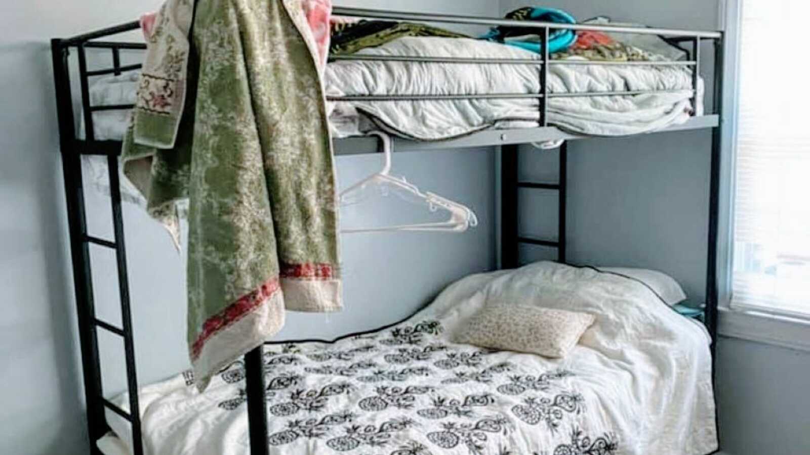 Mom of 3 takes a photo of her bed at a domestic abuse women's shelter