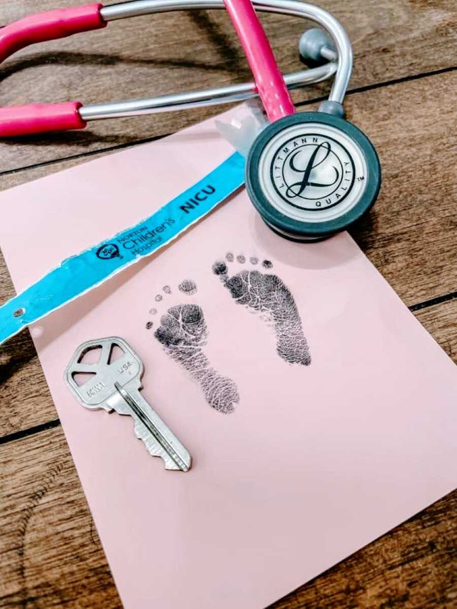 Mom shares photos of her NICU warrior's foot stamp, approximately the size of a key