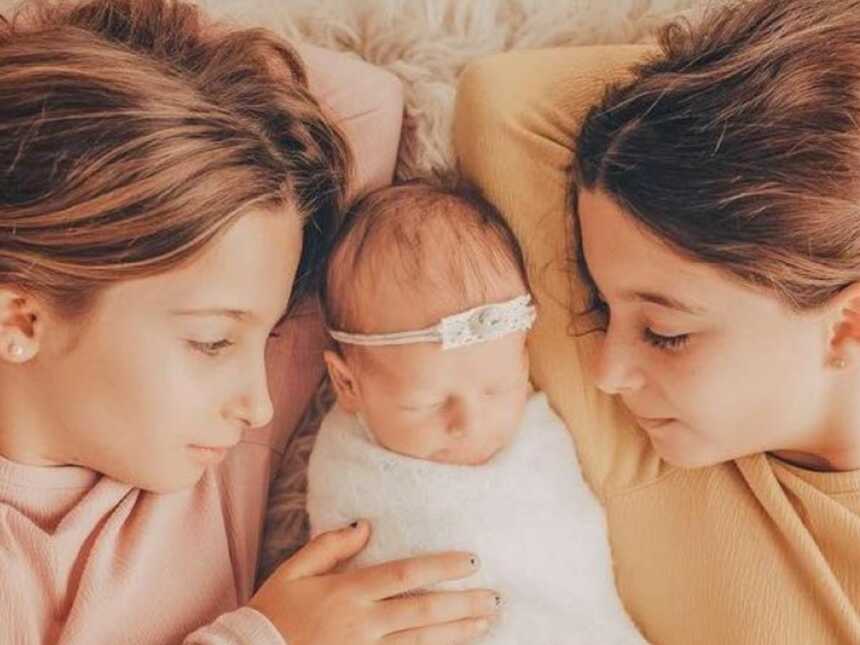 Mom shares beautiful photo of her three daughters cuddling and bonding with one another