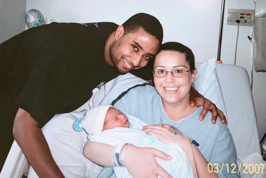 First time parents hold their newborn son in the hospital