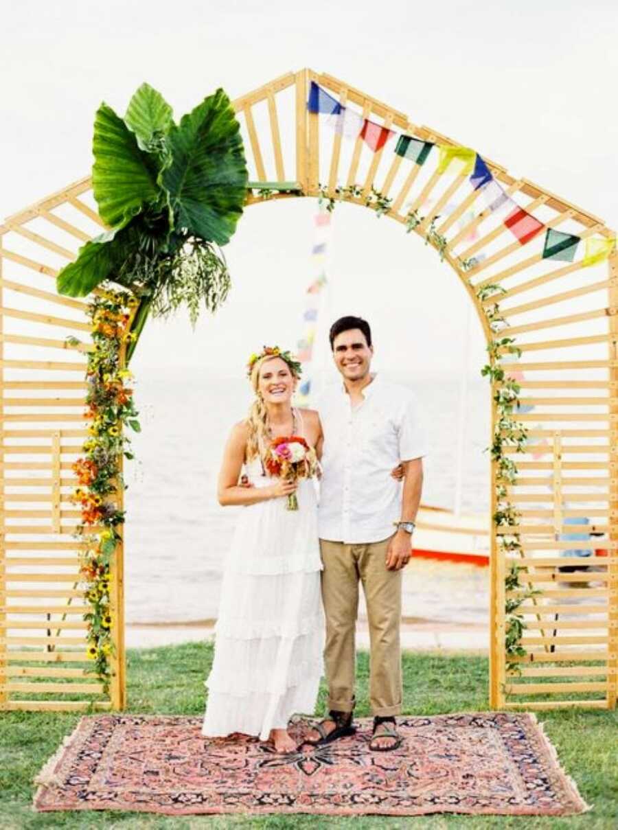 Young couple smile big while exchanging their vows to become married