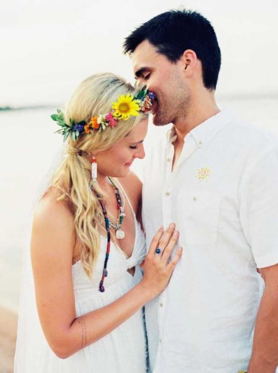 Young newlyweds take intimate photos together, showing off their love for one another as well as their unique boho style