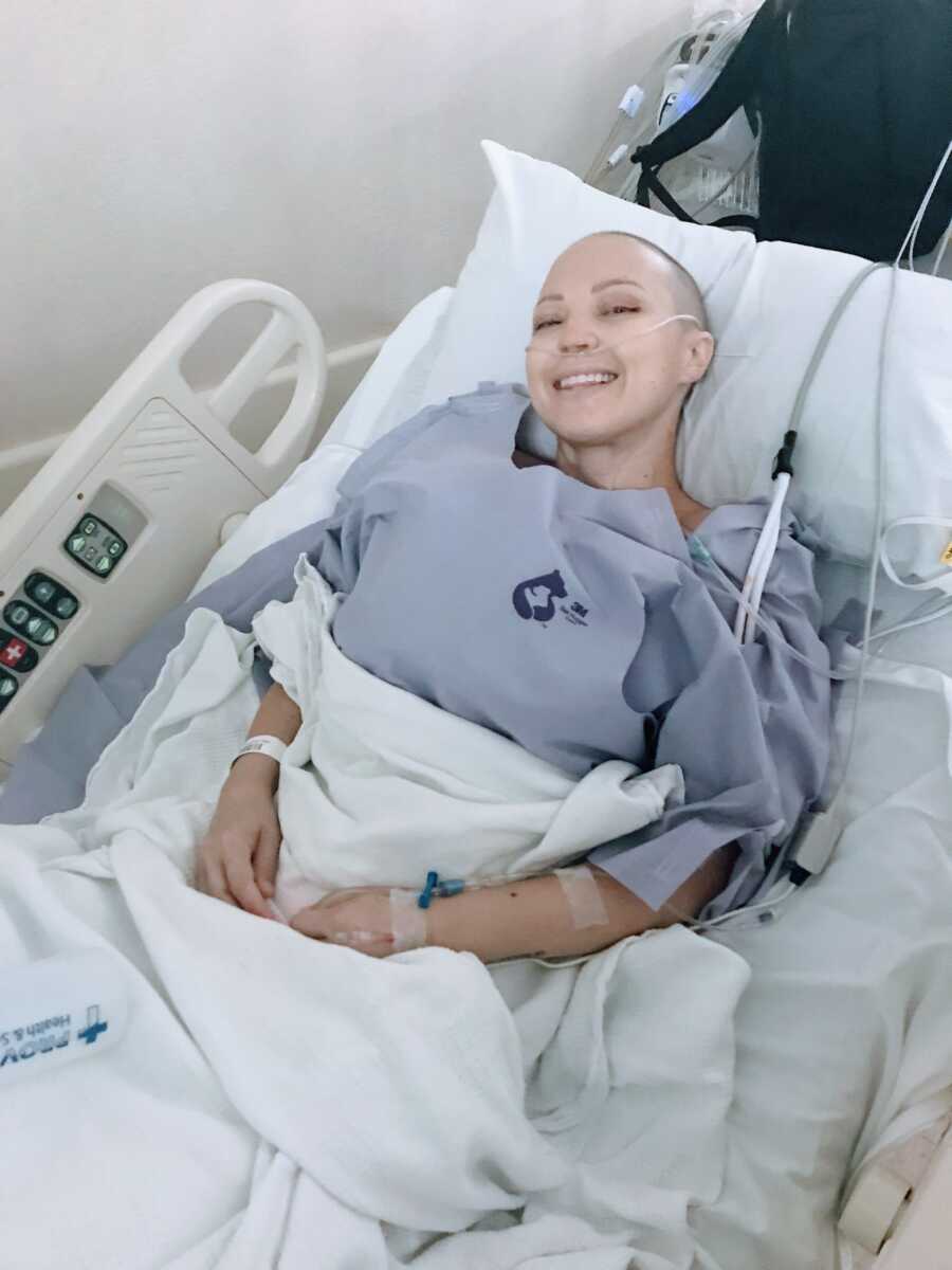 Woman battling breast cancer smiles during one of her chemotherapy treatments