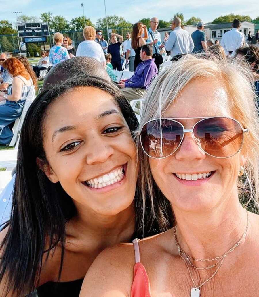 Mom and daughter take a selfie together while at a sporting event