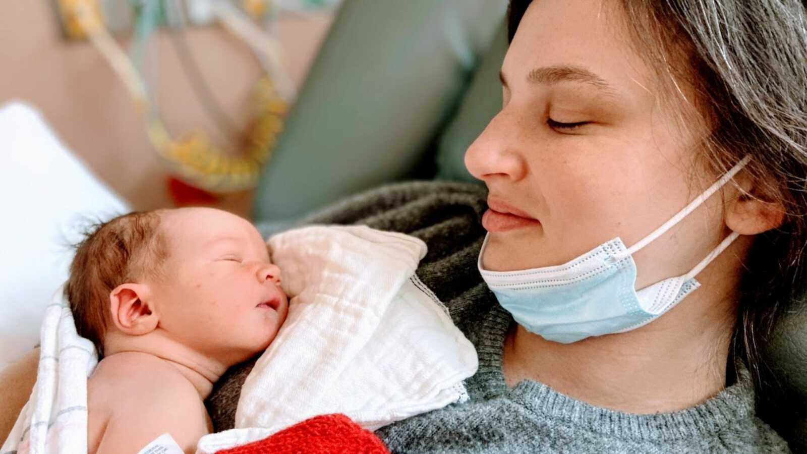 Mom shares tender moment with sleeping newborn son while still in the hospital