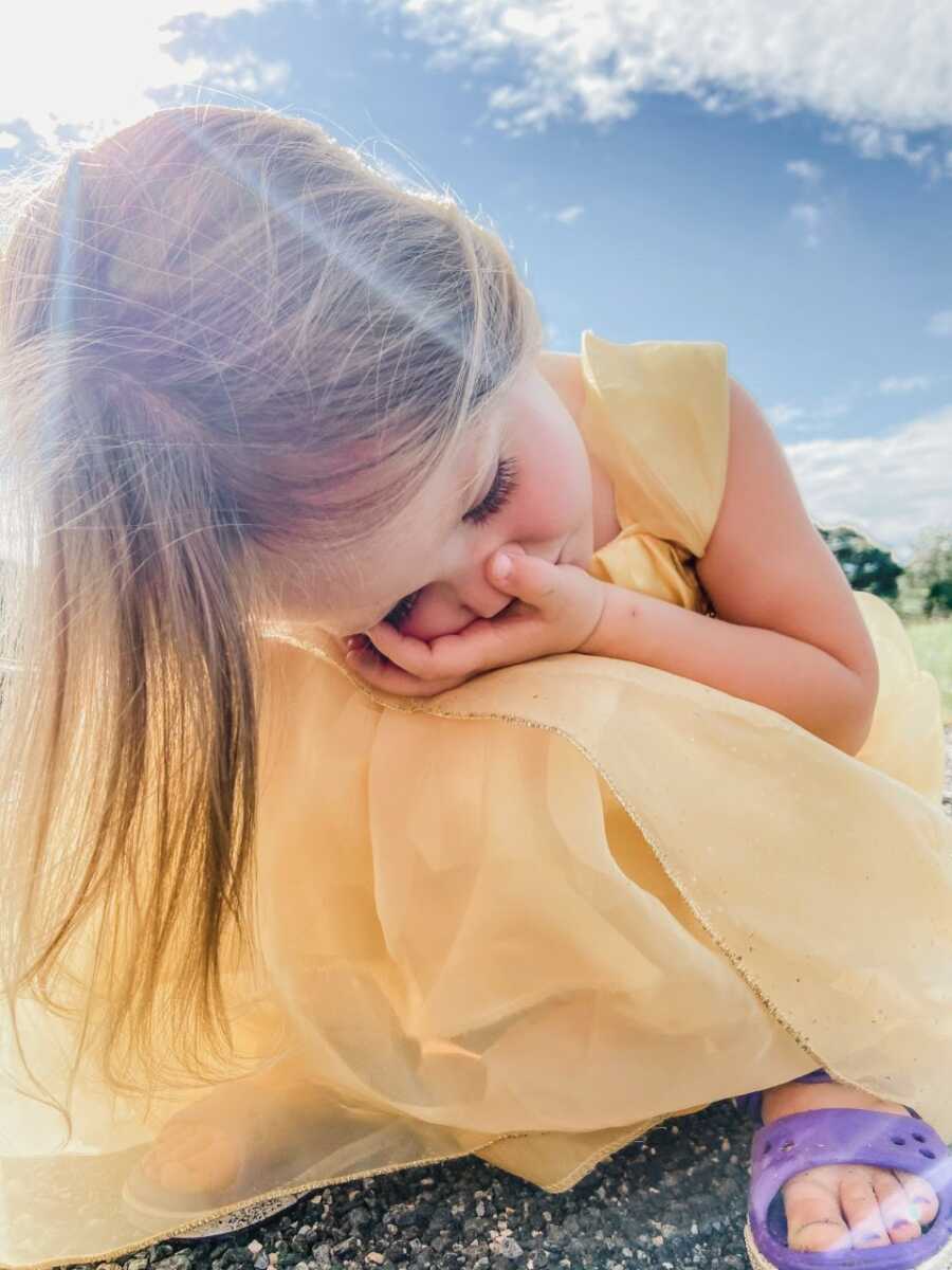 Mom snaps photo of her toddler crouching on the ground while experiencing anxiety