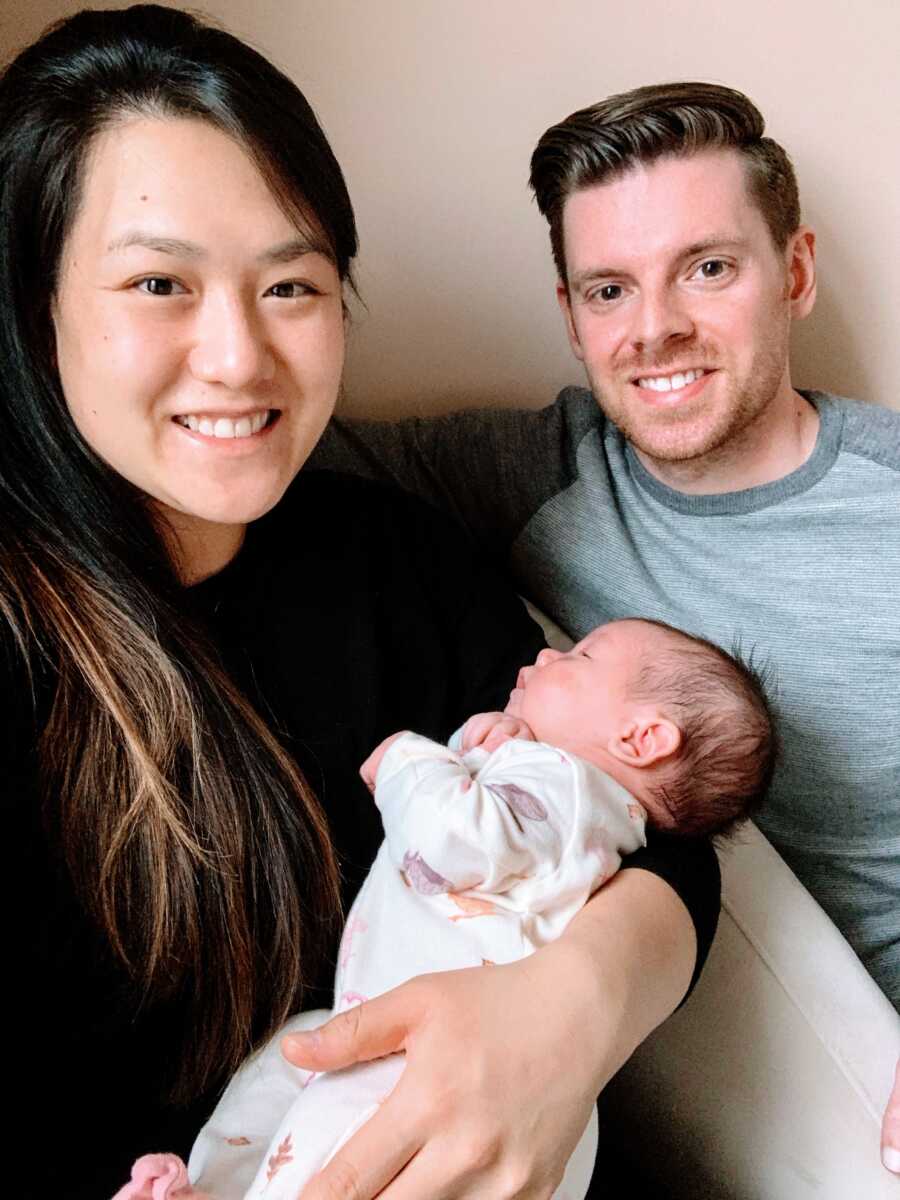 First time parents take a selfie with their medically complex child after getting to bring her home from the NICU